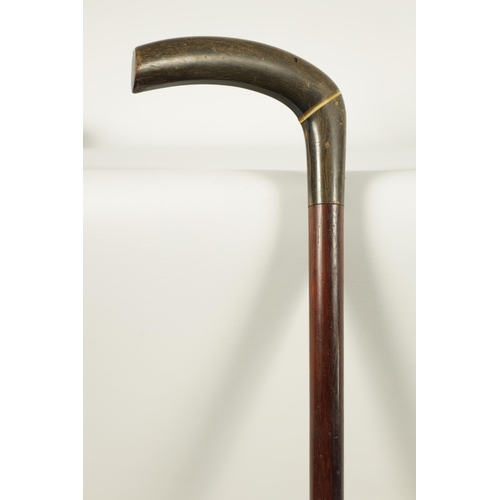 460 - A LATE 19TH CENTURY RHINOCEROS HORN HANDLED WALKING STICK the two-section handle on a mahogany shaft... 