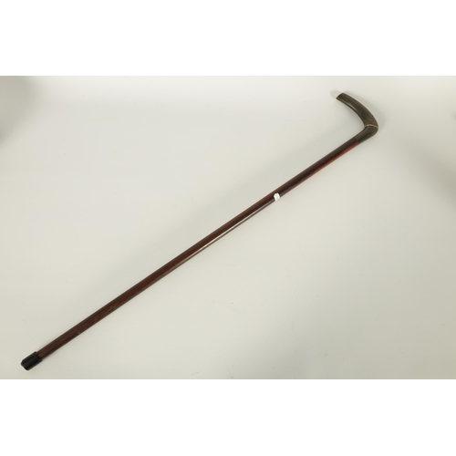 460 - A LATE 19TH CENTURY RHINOCEROS HORN HANDLED WALKING STICK the two-section handle on a mahogany shaft... 