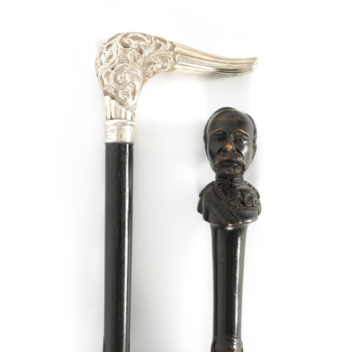 464 - TWO EARLY 20TH CENTURY SILVER MOUNTED PARASOLS one having an ebonised handle with carved bust of an ... 