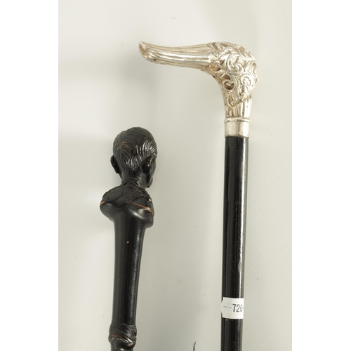 464 - TWO EARLY 20TH CENTURY SILVER MOUNTED PARASOLS one having an ebonised handle with carved bust of an ... 