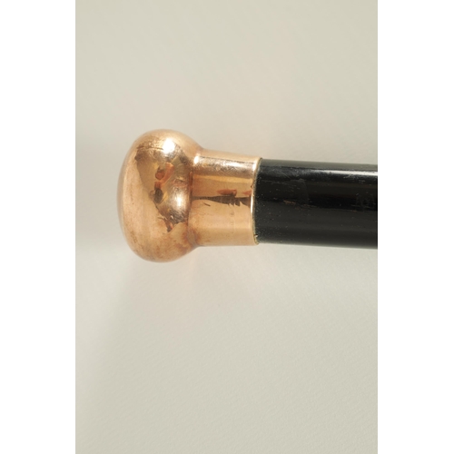 467 - A LATE 19TH CENTURY 9CT GOLD HANDLED WALKING STICK with ebonised tapering shaft - hallmarked .375 (8... 