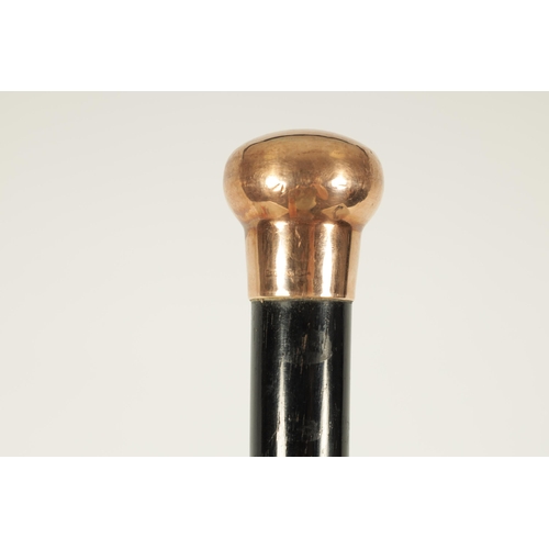 467 - A LATE 19TH CENTURY 9CT GOLD HANDLED WALKING STICK with ebonised tapering shaft - hallmarked .375 (8... 