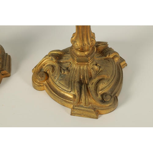 503 - A PAIR OF 19TH CENTURY FRENCH ROCOCO CAST GILT ORMOLU CANDLESTICKS with outset scrolled leafwork cir... 