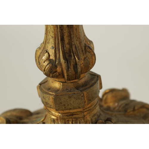 503 - A PAIR OF 19TH CENTURY FRENCH ROCOCO CAST GILT ORMOLU CANDLESTICKS with outset scrolled leafwork cir... 