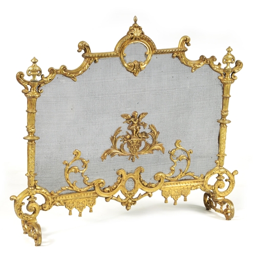 509 - AN EARLY 19TH CENTURY CAST BRASS ROCOCO FIRE SCREEN with leaf cast frame and scroll feet.