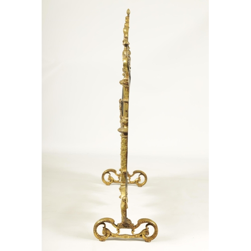 509 - AN EARLY 19TH CENTURY CAST BRASS ROCOCO FIRE SCREEN with leaf cast frame and scroll feet.