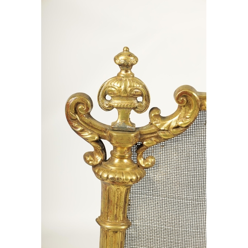 509 - AN EARLY 19TH CENTURY CAST BRASS ROCOCO FIRE SCREEN with leaf cast frame and scroll feet.