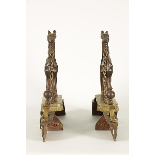 511 - A PAIR OF 19TH CENTURY CAST IRON AND BRASS MOUNTED HEARTH DOGS the seated hounds with decorated bodi... 