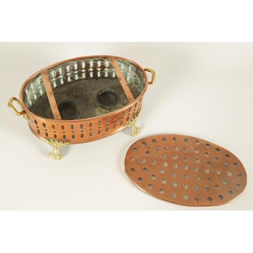 512 - AN UNUSUAL 19TH CENTURY BRASS AND COPPER TWO-HANDLED PIERCED OVAL FOOT WARMER raised on cast scrolle... 