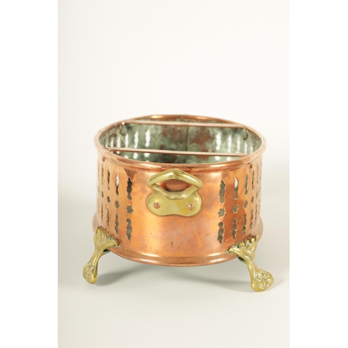 512 - AN UNUSUAL 19TH CENTURY BRASS AND COPPER TWO-HANDLED PIERCED OVAL FOOT WARMER raised on cast scrolle... 