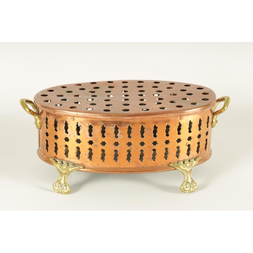 512 - AN UNUSUAL 19TH CENTURY BRASS AND COPPER TWO-HANDLED PIERCED OVAL FOOT WARMER raised on cast scrolle... 