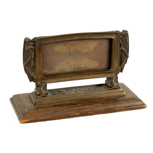 528 - A STYLISH ARTS AND CRAFTS BRONZE CARD DISPLAY STAND the moulded frame with locust sides on leaf cast... 