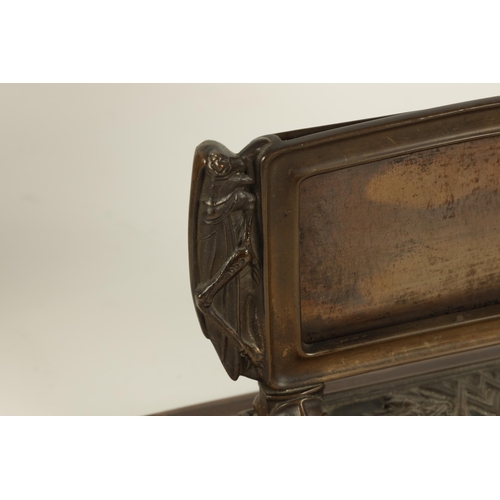 528 - A STYLISH ARTS AND CRAFTS BRONZE CARD DISPLAY STAND the moulded frame with locust sides on leaf cast... 