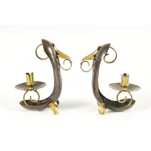 537 - ATTRIBUTED TO WILLIAM ARTHUR SMITH BENSON A STYLISH PAIR OF ARTS AND CRAFTS PATINATED COPPER AND BRA... 