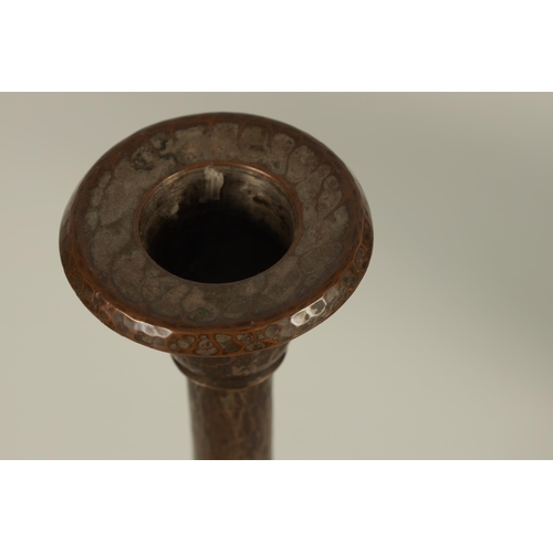 544 - A ROYCROFT SHEFFIELD ARTS AND CRAFTS PLANISHED PATINATED COPPER CANDLESTICK with circular base and p... 