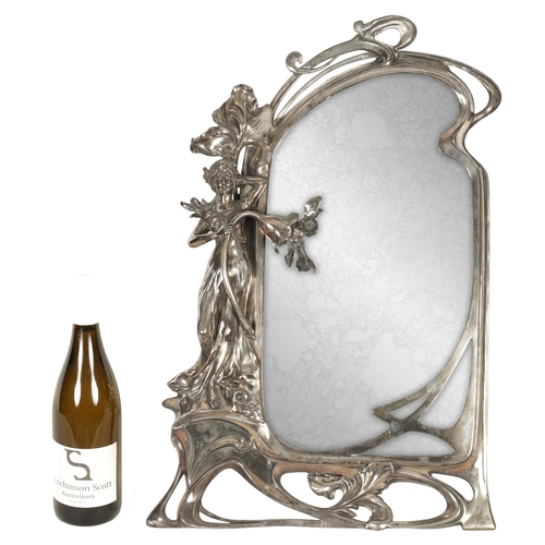 547 - AN ART NOVEAU WMF SILVER PLATED DRESSING TABLE MIRROR of shaped form with figural leaf and floral fr... 