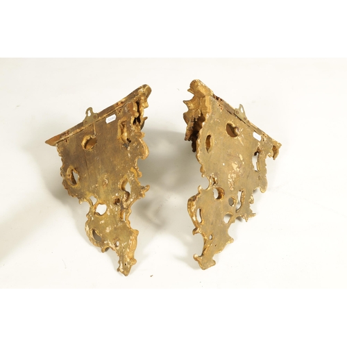 552 - A PAIR OF EARLY GEORGE III CARVED GILTWOOD WALL BRACKETS of scrollwork rococo design. (34cm high, 27... 