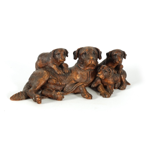 554 - A FINE 19TH CENTURY BLACK FOREST CARVED LINDEN-WOOD ANIMAL GROUP depicting a recumbent Dog with Pups... 