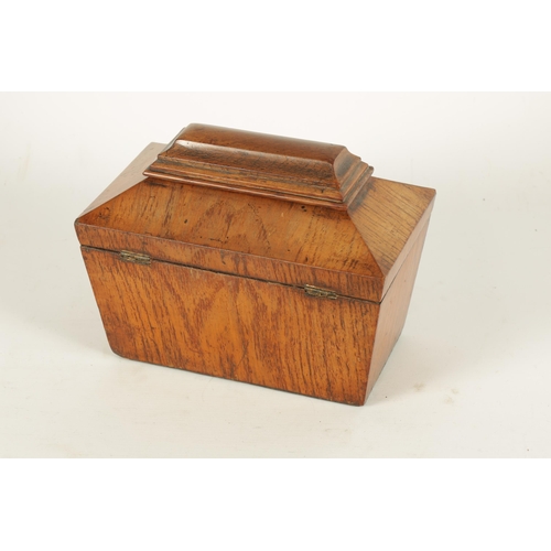 555 - A LATE REGENCY FIGURED OAK SARCOPHAGUS SHAPED TEA CADDY with inlaid burr maple lidded divided interi... 