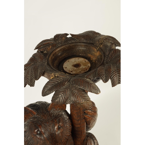 558 - A LATE 19TH CENTURY CARVED BLACK FOREST BEAR JARDINIERE STAND inset with glass and holding a palm tr... 