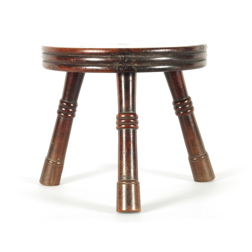 559 - AN EARLY/MID 19TH CENTURY YEW WOOD LOW STOOL the ribbed circular top on three ringed turned splay le... 