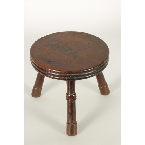 559 - AN EARLY/MID 19TH CENTURY YEW WOOD LOW STOOL the ribbed circular top on three ringed turned splay le... 