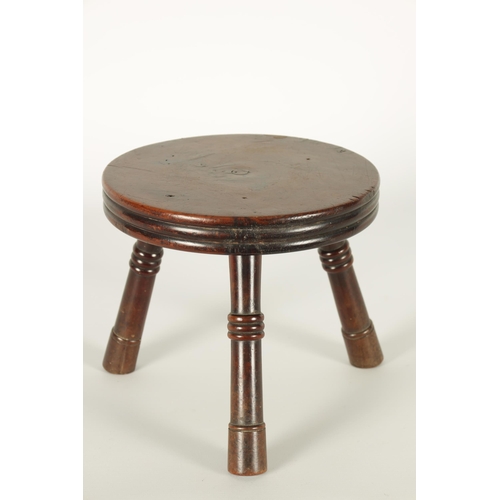 559 - AN EARLY/MID 19TH CENTURY YEW WOOD LOW STOOL the ribbed circular top on three ringed turned splay le... 