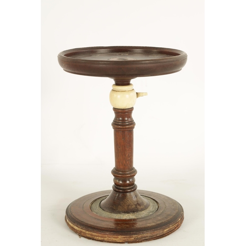 561 - AN 18TH CENTURY MAHOGANY ADJUSTABLE CANDLE STAND with inlaid ivory decorated top and turned stem wit... 