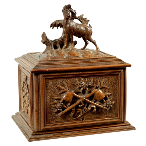 573 - A 19TH CENTURY CARVED BLACK FOREST CIGAR BOX the box surmounted by a carved deer on naturalistic bas... 