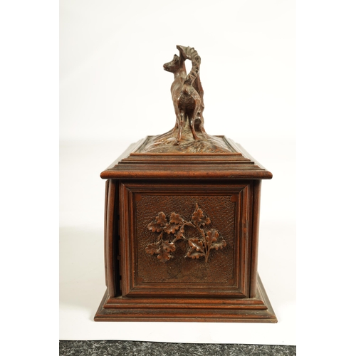 573 - A 19TH CENTURY CARVED BLACK FOREST CIGAR BOX the box surmounted by a carved deer on naturalistic bas... 