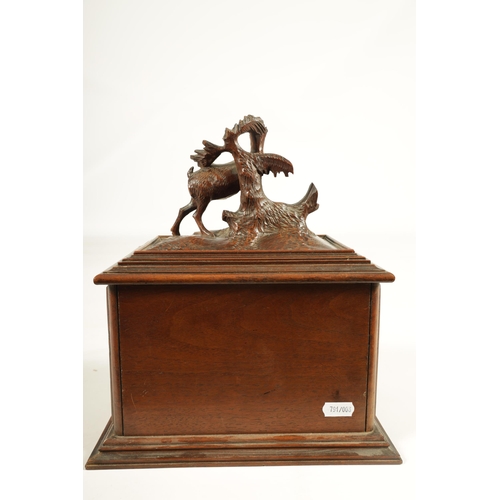 573 - A 19TH CENTURY CARVED BLACK FOREST CIGAR BOX the box surmounted by a carved deer on naturalistic bas... 