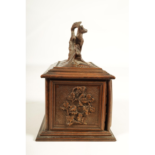 573 - A 19TH CENTURY CARVED BLACK FOREST CIGAR BOX the box surmounted by a carved deer on naturalistic bas... 