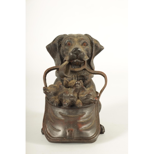 574 - A FINELY CARVED 19TH CENTURY BLACK FOREST DOGS HEAD INKWELL with hinged head and glass eyes depicitn... 