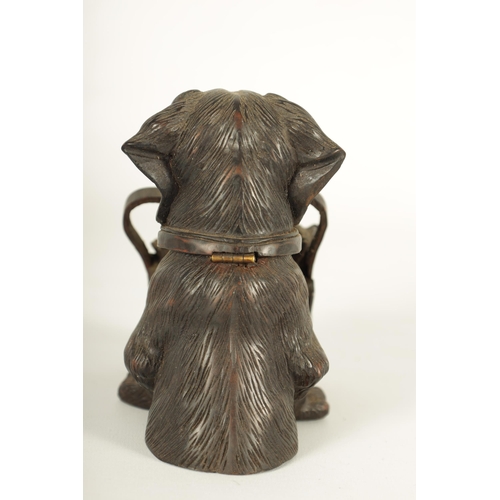 574 - A FINELY CARVED 19TH CENTURY BLACK FOREST DOGS HEAD INKWELL with hinged head and glass eyes depicitn... 