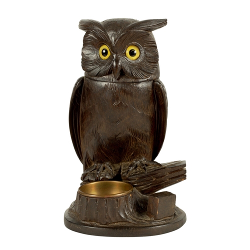 577 - AN EARLY 20TH CENTURY BLACK FOREST CARVED WOOD BIRD SCULPTURE OF AN OWL with hinged head and glass e... 