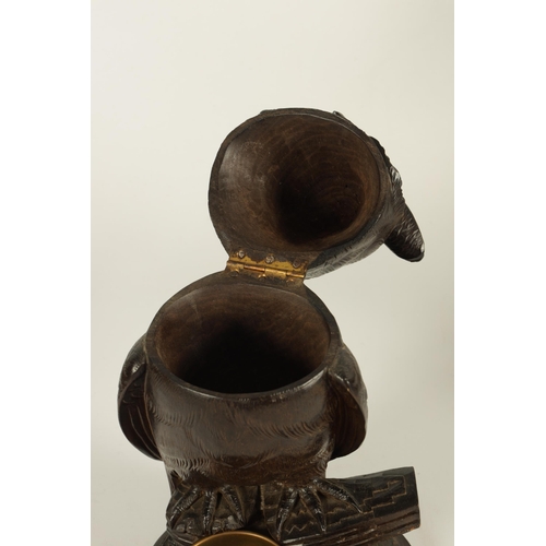 577 - AN EARLY 20TH CENTURY BLACK FOREST CARVED WOOD BIRD SCULPTURE OF AN OWL with hinged head and glass e... 