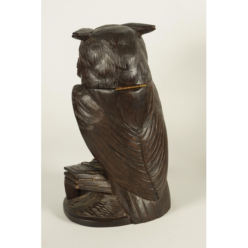 577 - AN EARLY 20TH CENTURY BLACK FOREST CARVED WOOD BIRD SCULPTURE OF AN OWL with hinged head and glass e... 