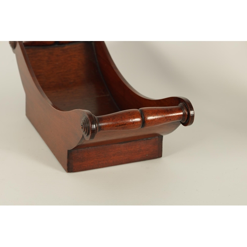 579 - A GEORGIAN BOAT SHAPED MAHOGANY CHEESE COASTER of dished form with turned side handles fronted by ro... 