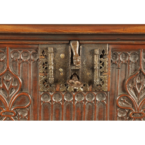 580 - A 16TH/17TH CENTURY SPANISH WALNUT GOTHIC TABLE CABINET the moulded edge hinged top with iron metal ... 