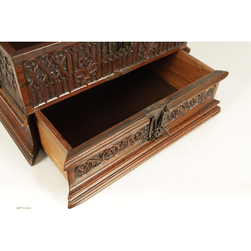 580 - A 16TH/17TH CENTURY SPANISH WALNUT GOTHIC TABLE CABINET the moulded edge hinged top with iron metal ... 