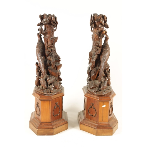 585 - A LARGE PAIR OF LATE 19TH CENTURY CARVED BLACK FOREST CANDLE STANDS modelled as cock and hen pheasan... 