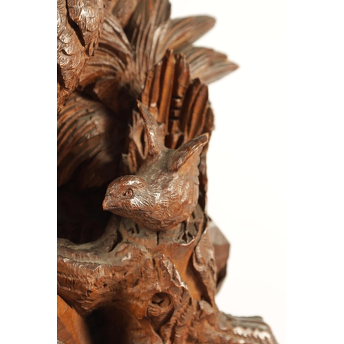 585 - A LARGE PAIR OF LATE 19TH CENTURY CARVED BLACK FOREST CANDLE STANDS modelled as cock and hen pheasan... 