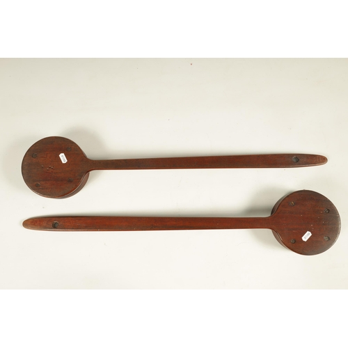 598 - A PAIR OF GEORGE III MAHOGANY LONG HANDLED ALMS DISHES - POSSIBLY SCOTTISH OR IRISH of ribbed circul... 