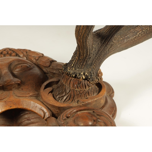 608 - A LARGE 19TH CENTURY MOUNTED BLACK FOREST PAIR OF STAGS HORN ANTLERS joined by a shaped carved walnu... 