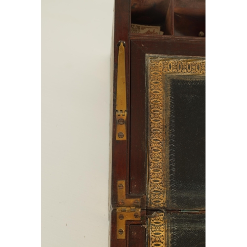 610 - A 19TH CENTURY BRASS BOUND MAHOGANY WRITING SLOPE with hinged angled writing surface and a fittted i... 