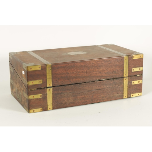 610 - A 19TH CENTURY BRASS BOUND MAHOGANY WRITING SLOPE with hinged angled writing surface and a fittted i... 