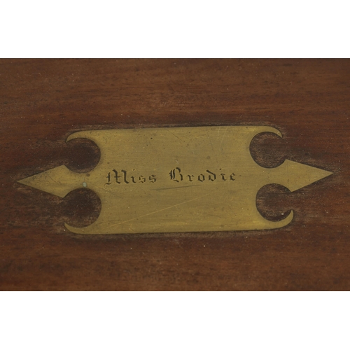 610 - A 19TH CENTURY BRASS BOUND MAHOGANY WRITING SLOPE with hinged angled writing surface and a fittted i... 