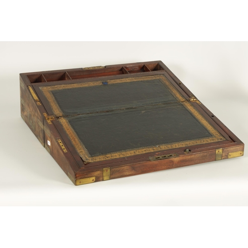 610 - A 19TH CENTURY BRASS BOUND MAHOGANY WRITING SLOPE with hinged angled writing surface and a fittted i... 