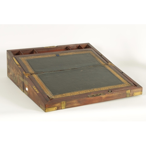 610 - A 19TH CENTURY BRASS BOUND MAHOGANY WRITING SLOPE with hinged angled writing surface and a fittted i... 