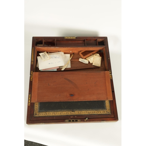 610 - A 19TH CENTURY BRASS BOUND MAHOGANY WRITING SLOPE with hinged angled writing surface and a fittted i... 